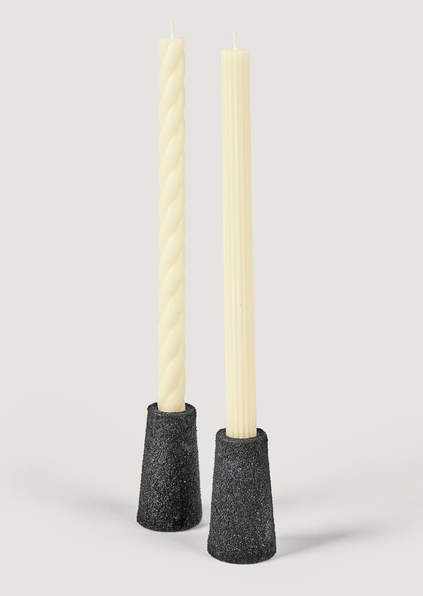 http://www.afloral.com/cdn/shop/files/Black-Pumice-Texture-Taper-Holders-Styled-with-Cream-Candles.jpg?v=1702956578