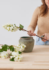 arranging faux lilac branches with chicken wire