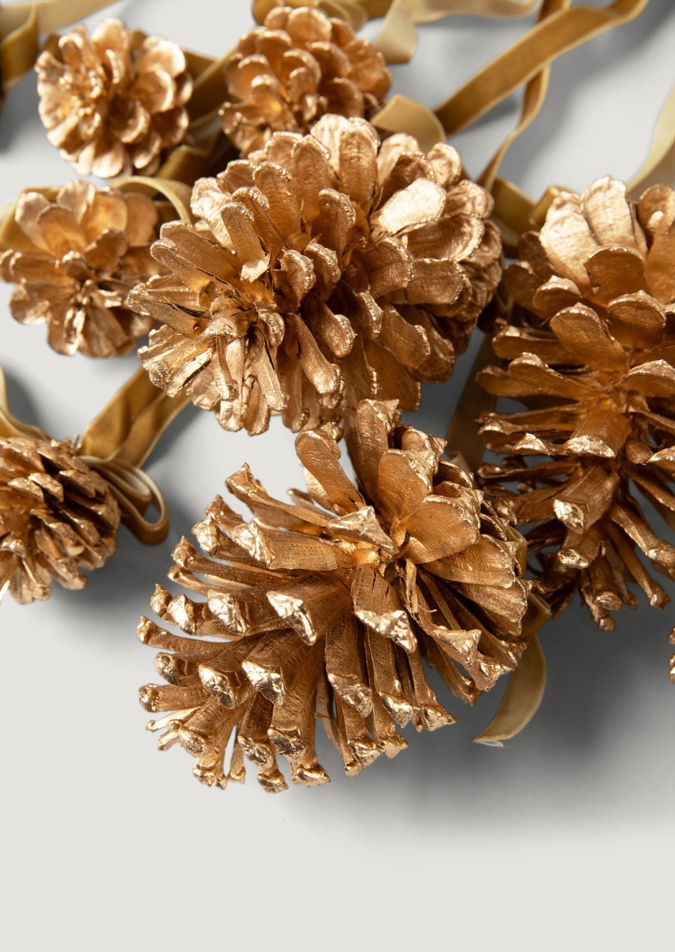Close Up of Gold Pine Cones and Ribbon in Hanging Christmas Decoration Ornament