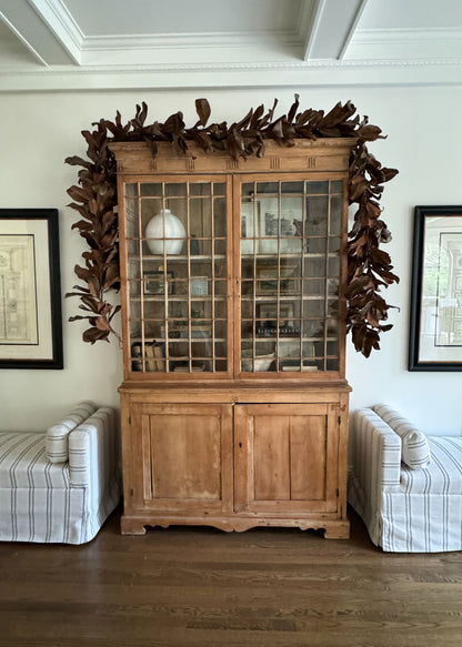 Magnolia Garland Decorating a Cabinet