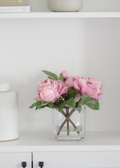 pink peony arrangement on bookcase