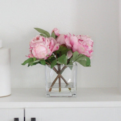 pink peony arrangement on bookcase