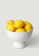 Artificial Lemons in a Large White Ceramic Compote